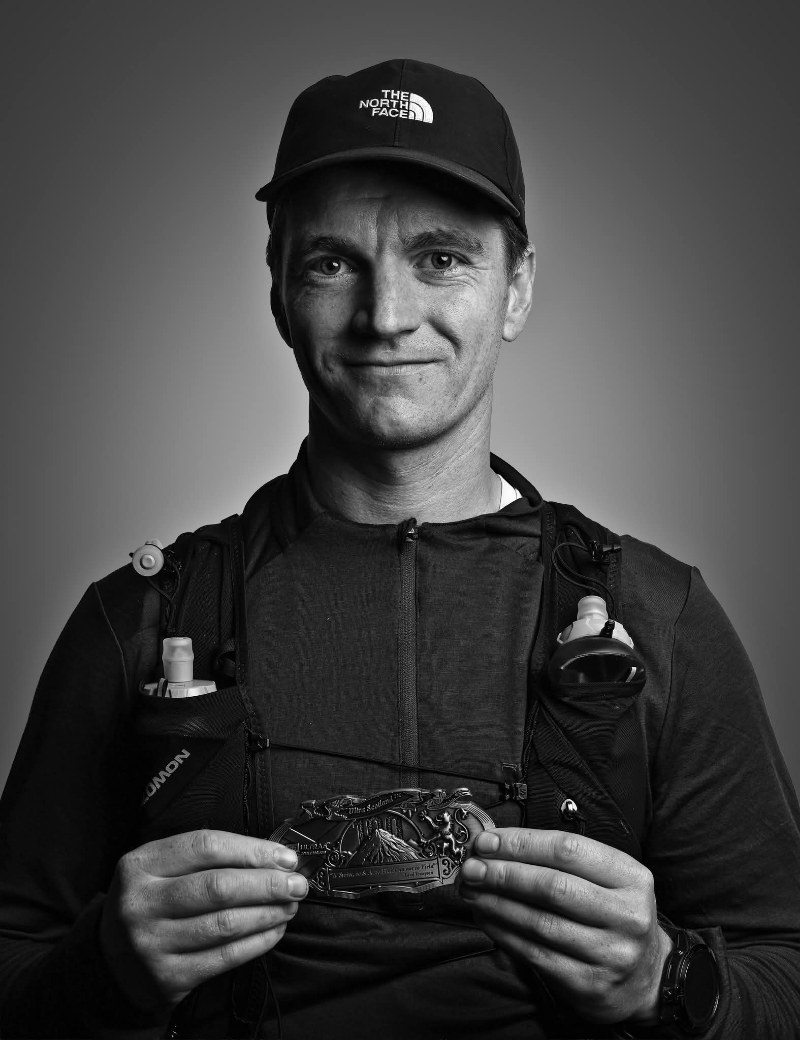 Jacob Lockhart Lister, Health and Performance Coach at DVOTION Labs, wearing a cap and glasses