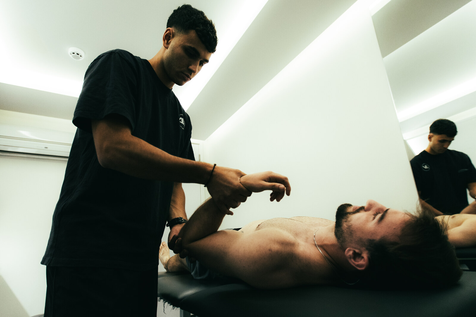 Coach assessing shoulder and arm range at DVOTION London